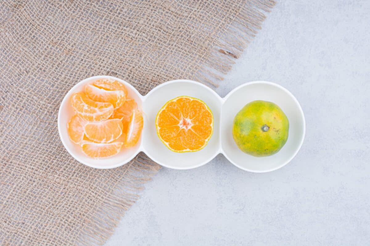 white plates peeled tangerines sackcloth